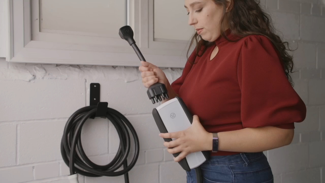 Woman using Pion Power charging adapter